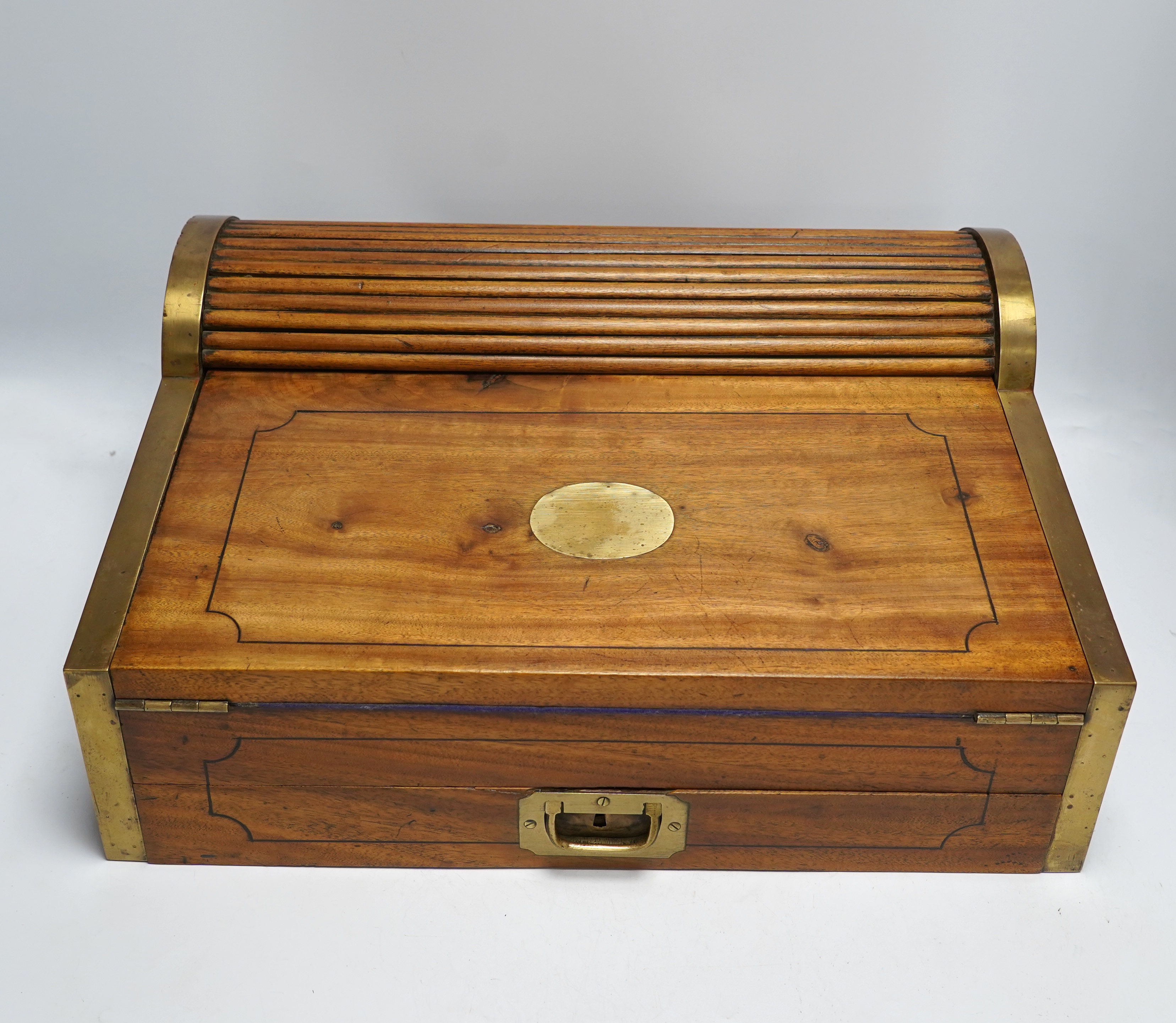 A 19th/20th century Anglo-Indian brass bound camphorwood roll top writing box, 47.5cm wide
